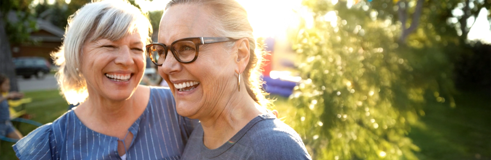 two women laughing together outside