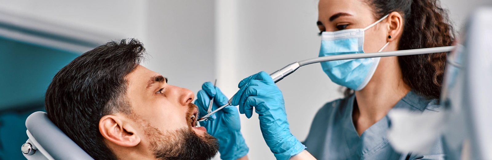 man-getting-a-dental-exam-1600x522.webp