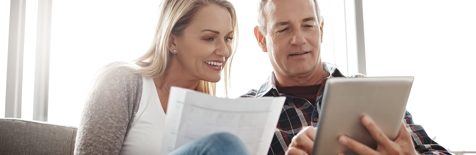 older-couple-looking-tablet-1600x522.webp