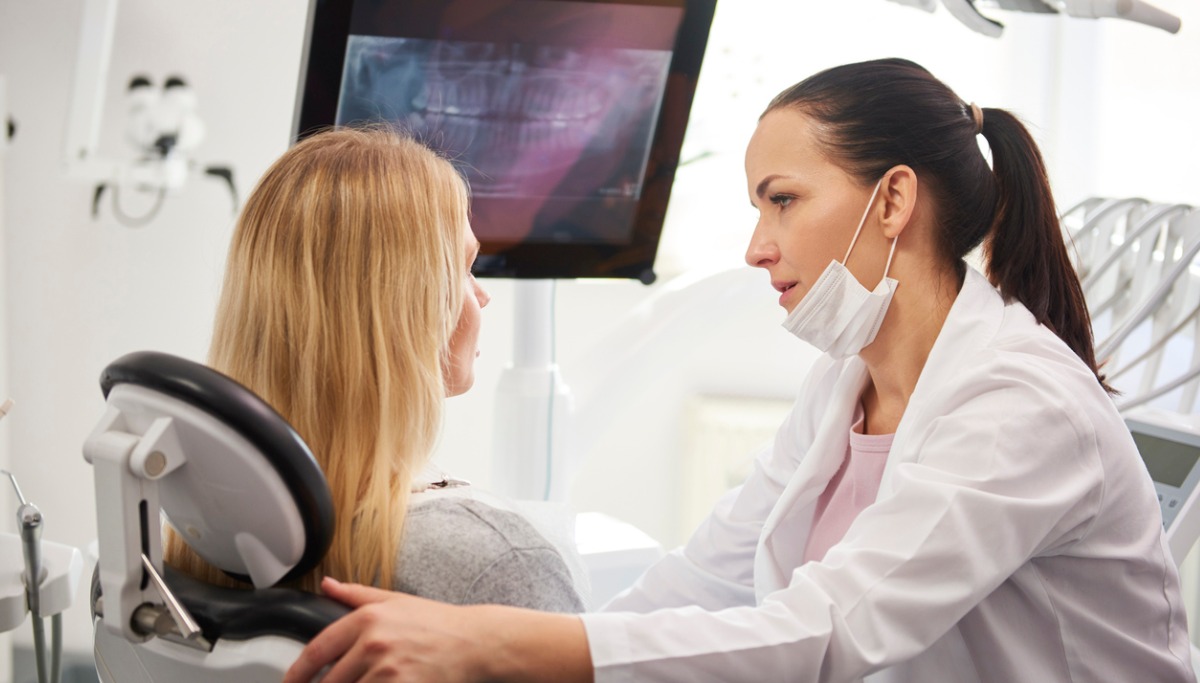 dentist-talking-to-worried-woman-during-dental-checkup-picture-1200x683.jpg