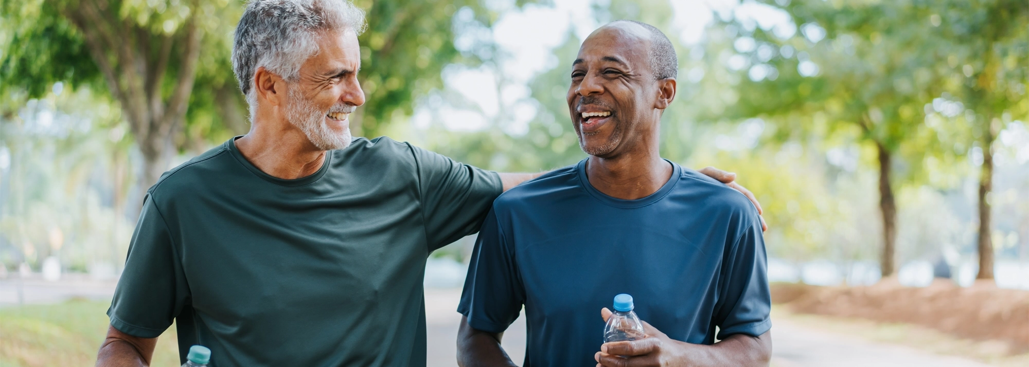 men-smiling-on-a-walk-2000x714.webp