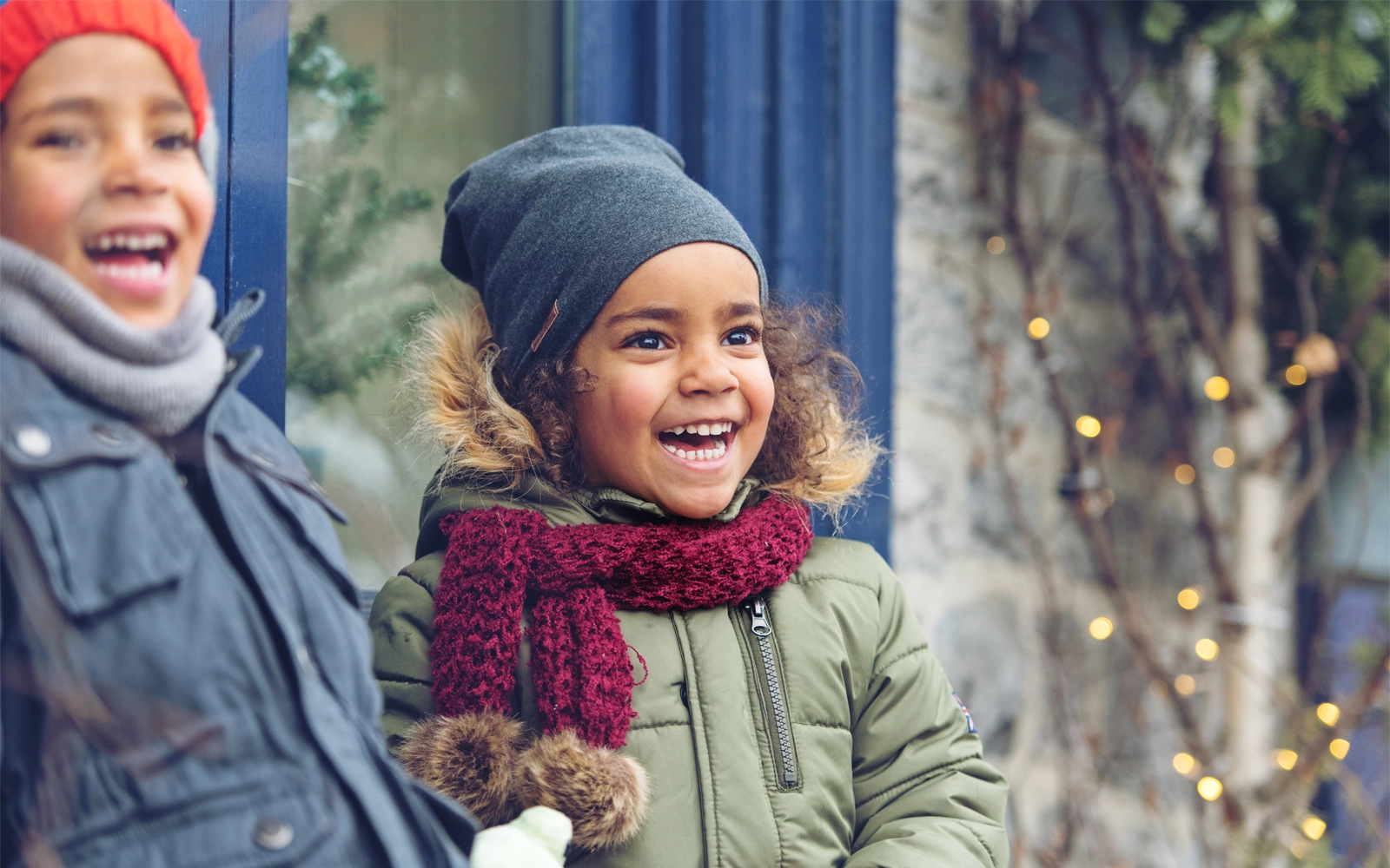 children-smiling-outside-in-the-winter-1600x1000.webp