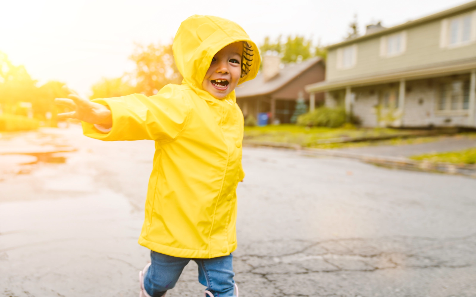 young_child_playing_in_raincoat_1600x1000.webp