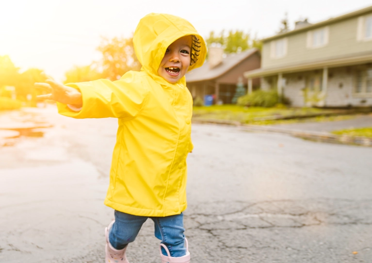 young_child_playing_in_raincoat_767x544.webp